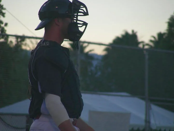 Sean Ramalho in full catcher's gear at dusk during his playing career